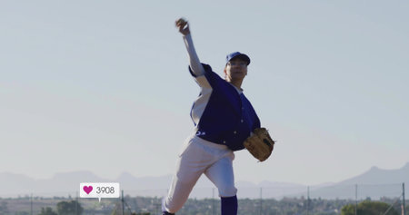 Pitching lone baseball player releasing baseball on field under clear sky, with leather glove. Athlete, sports, action, outdoor, competitive, athleticism, dynamicの写真素材