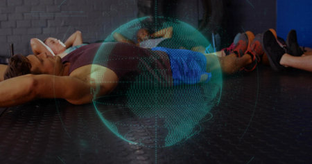 Projecting holographic globe hovering above six exercisers resting on gym floor with earphones....