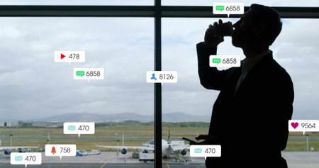 Man holding coffee cup checking phone at airport gate window with jet, notifications, copy space. Corporate, travel, professional, technology, connectivity, modern, skylineの写真素材