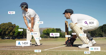Holding bat wearing helmet, batsman and keeper crouching at stumps on field, showing graphic icons....