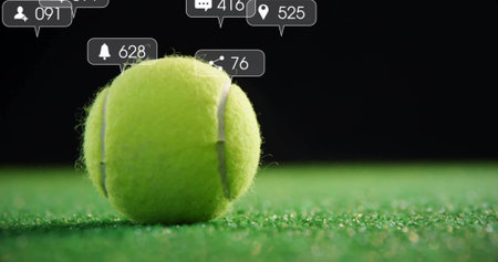 Resting single yellow-green tennis ball on artificial court turf, with social media UI bubbles. Sports, leisure, vibrant, digital, engaging, outdoor, competitiveの写真素材