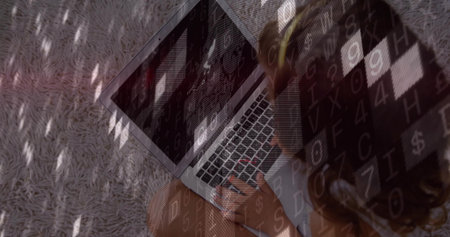 Typing child sitting on light gray shag rug, with glowing laptop keyboard, code overlay, copy space. Technology, innovation, education, minimalism, digital, youth, comfortの写真素材