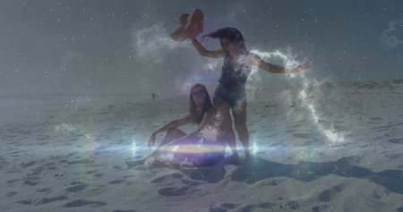 Laughing man in trunks and sunglasses, friend in swimsuit lifting straw hat at beach, cosmic effect....