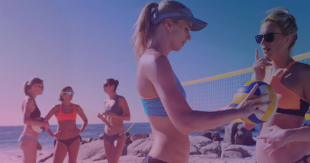 Chatting five women in bikinis preparing beach volleyball on court, with volleyball and net. Summertime, friendship, outdoor, active, vibrant, leisure, teamworkの写真素材