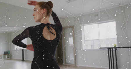 Practicing lone dancer wearing black leotard stretching at ballet studio barre, copy space. Elegant,...