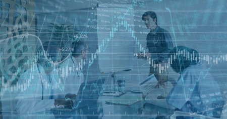 Presenting man in dark shirt explaining stock market charts in boardroom, with flipchart, laptops....