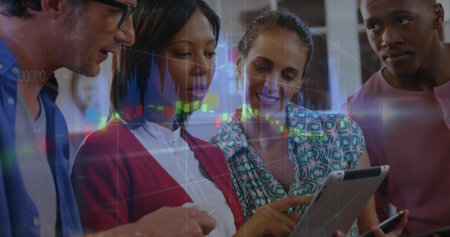 Four professionals analyzing financial charts in office, with digital tablet and smartphone. Collaboration, teamwork, modern, technology, finance, business, corporateの写真素材