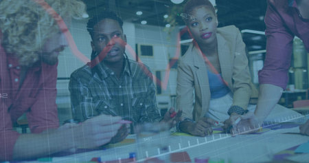 Collaborating project team analyzing in office workspace, with documents and prototype blocks. Teamwork, innovation, brainstorming, modern, productivity, analytics, professionalの写真素材