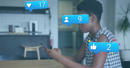 Checking checkered top woman viewing notification icons on smartphone in bright kitchen, copy space....