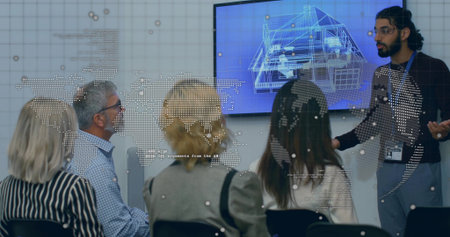 Presenting Indian presenter gesturing at blueprint screen with map overlay in boardroom, copy space....
