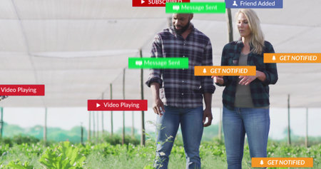 Walking coworkers through crop rows under shade net poles, with notification and playback banners....