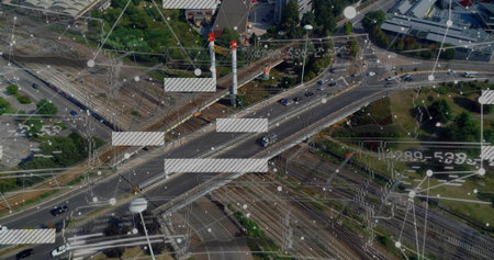 Spanning overpass carrying cars over tracks at outskirts, with network nodes, lines and light poles. Infrastructure, connectivity, transportation, urban, technological, modern, logisticsの写真素材