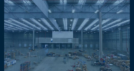 Displaying white-walled mezzanine office structure inside distribution center, with wooden pallets....