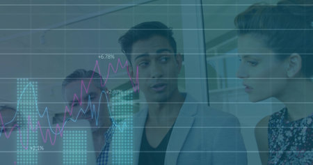 Speaking Indian man in gray blazer presenting financial charts around conference table in office. Professionalism, teamwork, data analysis, corporate, modern, collaboration, strategyの写真素材