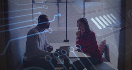 Business colleagues discussing tech project in office lounge booth, with laptop and tech overlay. Collaboration, innovation, strategy, communication, modernoffice, teamwork, digitalの写真素材