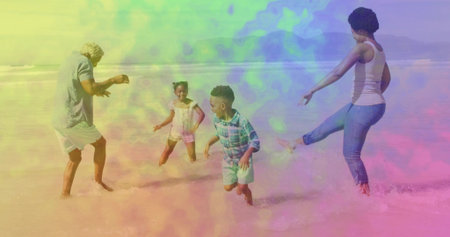 Splashing family wearing beachwear and kicking shallow ocean water on sandy beach, with small waves. Joy, celebration, leisure, natural, vibrant, candid, outdoorの写真素材
