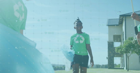 Holding translucent bag, boy collecting litter on neighborhood lawn, with recycling-themed T-shirt. Environmentalism, community, eco-friendly, outdoor, youth, conservation, sustainabilityの写真素材