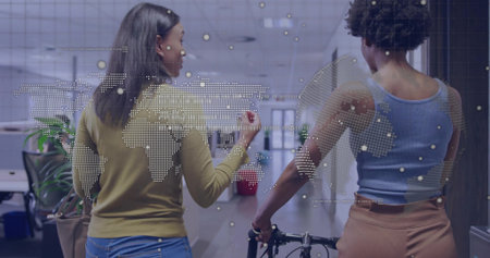 Walking two women coworkers carrying bicycle frame and talking in office corridor, with map overlay. Collaboration, innovation, professional, futuristic, urban, workspace, connectivityの写真素材
