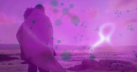 Wrapping couple standing on rocky shore at dusk with blanket and molecular overlay, copy space. Romance, connection, serenity, geology, landscapeの写真素材