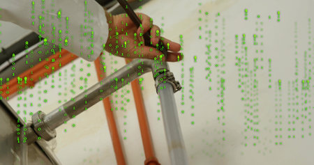 Technician's hand tightening hose clamp on pipe in utility room, with binary code, orange conduit....