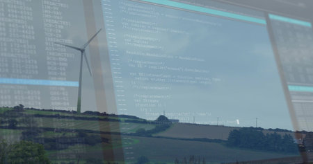 Showing white wind turbine rotating on distant hill, with code overlay on glass panel. Technology,...