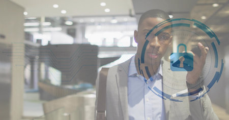 Executive tapping smartphone screen verifying identity in airport terminal, with padlock interface. Corporate, security, technology, professional, modern, authentication, travelの写真素材