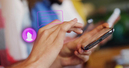 Tapping smartphone screen, hands holding device over wooden cafe table, with chat bubble overlay....