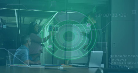 Pointing woman in business attire presenting charts at glass wall in conference room, with laptop. Collaboration, teamwork, brainstorming, strategy, professional, innovative, corporateの写真素材