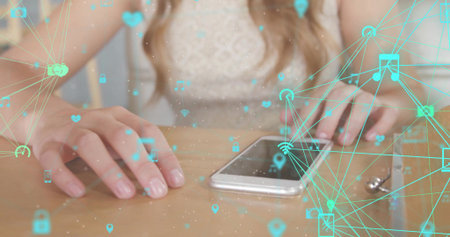 Sitting woman using smartphone and computer mouse at home office desk, with network icon overlays....