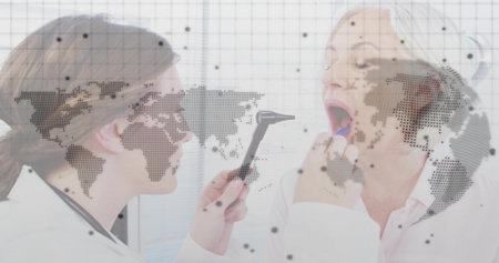 Examining doctor holding otoscope near seated patient tongue in exam room, digital overlay. Healthcare, telemedicine, biomedical, diagnostics, clinical, professional, medical technologyの写真素材