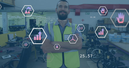 Crossing arms adult male wearing safety vest in workshop, with monitors, wheelchairs and AR icons. Industrial, manufacturing, technology, innovation, engineering, automation, productivityの写真素材