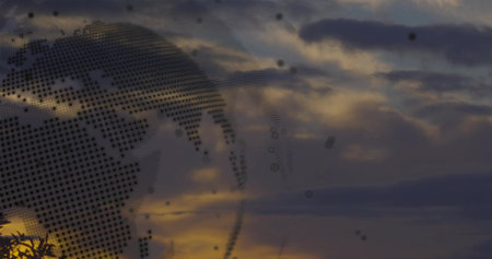 Presenting digital globe dotting continents over dusk sky, with purple orange clouds, copy space. Geography, technology, abstract, innovation, futurism, landscape, atmosphericの写真素材