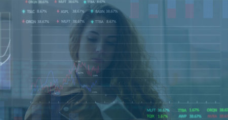 Businesswoman in white blouse reviewing stock charts on phone in office, finance data. Professional,...