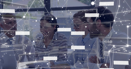 Reviewing colleagues discussing network diagrams at conference desk, with laptop and data overlays. Corporate, teamwork, innovation, connectivity, digital, modern, businessの写真素材