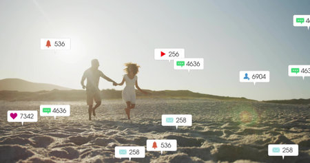 Running couple in summer clothes holding hands on rippling beach. Romantic, leisure, vibrant,...