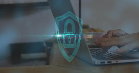 Typing hands securing network on wooden desk at office, with laptop shield overlay and pastries. Technology, cybersecurity, innovation, workspace, digital, protection, professionalismの写真素材