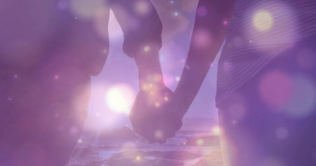 Silhouette couple wearing beach dress and striped shirt holding hands on sunset beach, with bokeh. Romance, harmony, serenity, twilight, leisure, connection, tranquilityの写真素材