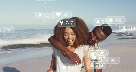 Embracing couple wearing casual tops standing on sandy beach. Romance, affection, connection,...
