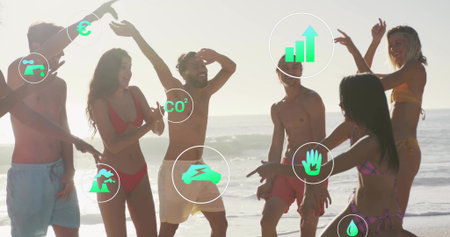 Celebrating friends dancing at beach shoreline. Beach, celebration, diversity, leisure, wellnessの写真素材