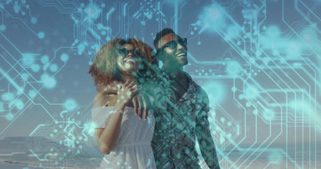 Hugging couple gazing at beach shoreline, wearing sunglasses. Romantic, serenity, elegance, connection, tranquilityの写真素材