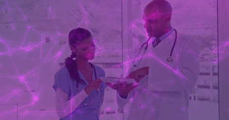 Doctor in coat and nurse in scrubs examining chart at clinic, with stethoscopes and magenta overlay....