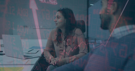 Presenting market data, woman wearing blouse in conference room, with laptop notebook table chairs. Business, teamwork, innovation, analytics, corporate, collaboration, professionalの写真素材