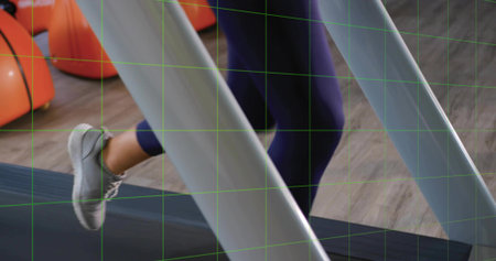 Jogging woman in navy leggings on treadmill belt in gym, with orange kettlebells on wooden floor....