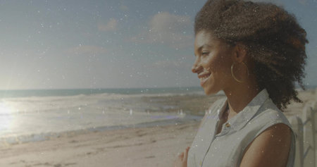 Leaning woman gazing toward horizon at sandy beach, with wooden barrier and ocean waves, copy space....