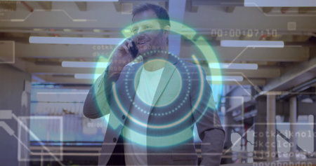 Holding smartphone to ear and smiling businessman in open-plan office, with digital HUD overlay. Corporate, networking, innovation, technology, collaboration, modernity, productivityの写真素材