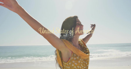 Woman stretching arms toward sun on beach, with yellow sundress. Coastal, relaxation, freedom,...