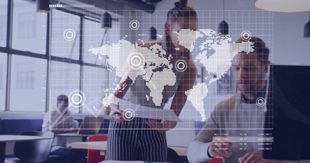 Collaborating female and male examining world map data overlay at modern office space, with tablet....