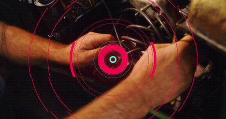 Tightening mechanic forearms gripping coil spring in engine bay at shop, with HUD graphics. Mechanic, industrial, digital, maintenance, precision, engineering, technologyの写真素材