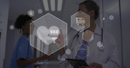 Interacting female doctor manipulating icons in midair with tablet in hospital hallway, copy space. Medical, healthcare, technology, professionalism, digital, collaboration, modernの写真素材