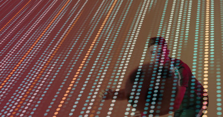 Leaning forward man wearing red jacket interacting with LED panel in gallery space, copy space. Interactive, futurism, digital art, immersive, technology, modern, creativeの写真素材